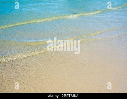 Light reflection on the surface of movement sea on sand beach Stock Photo