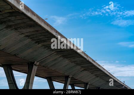 Bottom view of elevated concrete highway. Overpass concrete road. Road flyover structure. Modern motorway. Transportation infrastructure. Concrete Stock Photo