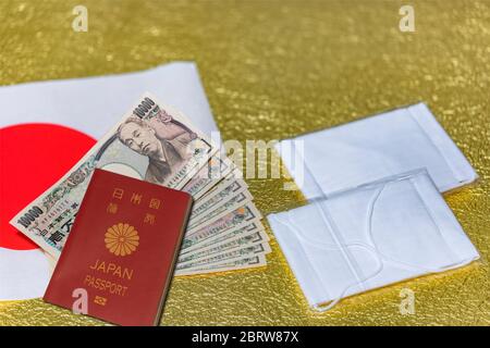 tokyo, japan - may 20 2020: Cloth masks and 100000 yen in cash sent by the Japanese govt to fight against coronavirus (COVID-19) and unemployment with Stock Photo