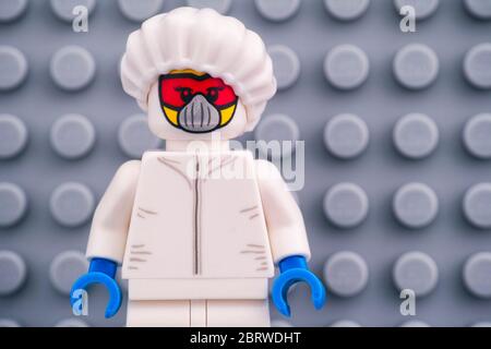 Tambov, Russian Federation - April 30, 2020 Lego minifigurein protective suit against gray baseplate. Studio shot. Stock Photo