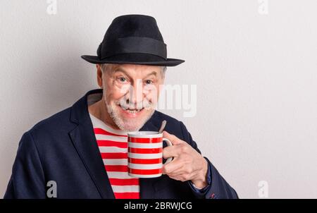 Side view portrait of a senior man in a studio. Copy space. Stock Photo