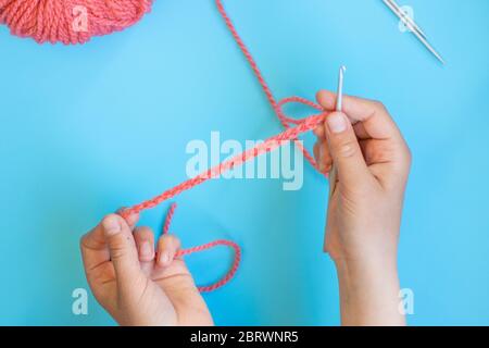 Step-by-step instructions for children how to crochet a bracelet from yarn Stock Photo