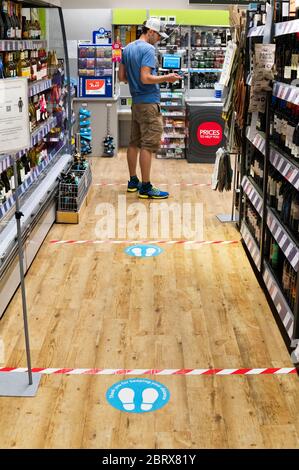 Covid-19 social distancing floor markings at the checkout of the Coop store in Settle, North Yorkshire, UK