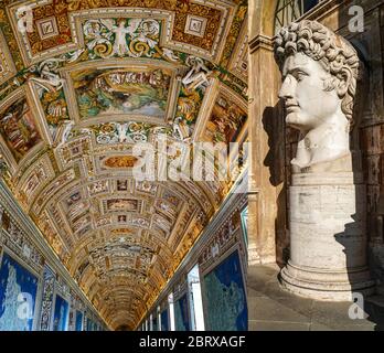 caesar augustus head statue near paintings on walls and ceiling in gallery of maps at vatican museum Stock Photo