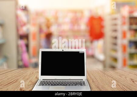 Laptop with blank screen on table, Blurred background at light bokeh. Stock Photo