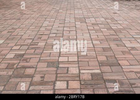 Perspective view brick stone pavement on the ground for Street Road. Vintage ground flooring square pattern texture for mock up. Stock Photo