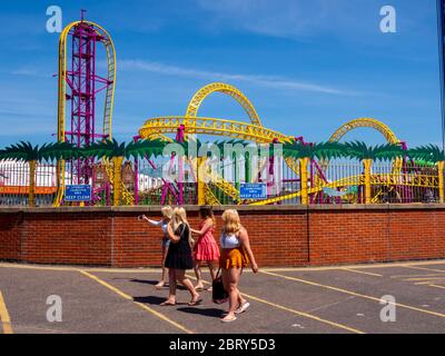 Girl friends walk past Adventure Island in Southend, closed duting the coronavirus pandemic. Stock Photo