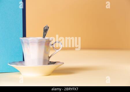 Asymmetric, abstract geometric background with a cup of coffee and a plant Stock Photo