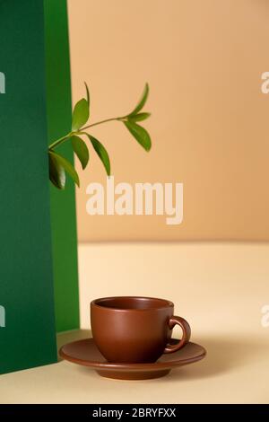 Asymmetric, abstract geometric background with a cup of coffee and a plant Stock Photo