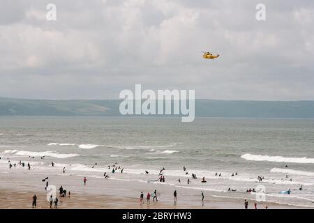 RAF Westland WS-61 Sea King search and rescue helicopter on patrol to check all is well with surfers and swimmers on the beach in Croyde Bay, Devon. Stock Photo