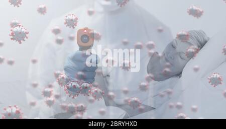 Healthcare worker wearing face mask over macro coronavirus covid19 cells spreading Stock Photo