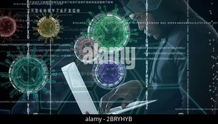 Hacker using laptop with colorful coronavirus covid cells floating over data processing Stock Photo