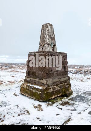 Snowy winter view of the trig point on the summit of The Cheviot in Northumberland National Park Stock Photo