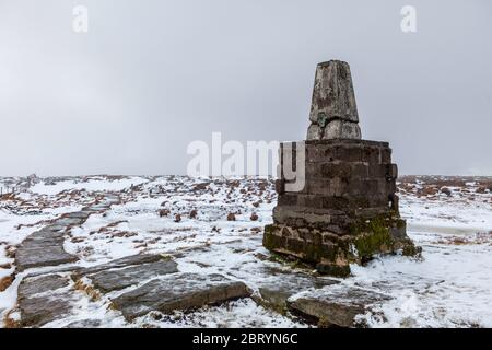 Snowy winter view of the trig point on the summit of The Cheviot in Northumberland National Park Stock Photo