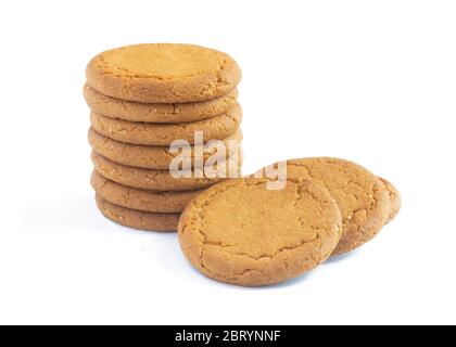 close up plie of ginger biscuits with more behind   isolated on a white background Stock Photo