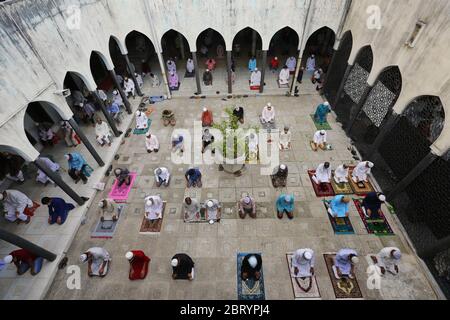 Muslims offer prayers on the last Friday (Jummah tul bidah) of the Islamic holy fasting month of Ramadan at the Baitul Mokarrn National mosque amid Coronavirus (COVID-19) crisis.The holy month of Ramadan is a momentum for Muslims around the world to draw closer to Allah SWT (Subhanahu wa ta'ala) by expanding the Sunnah prayer, Dhikr, and Tadarus Al Quran. Stock Photo