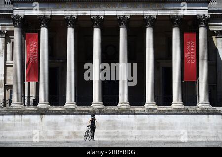 A cyclist in front of The National Gallery in Trafalgar Square, London, after the introduction of measures to bring the country out of lockdown. Stock Photo