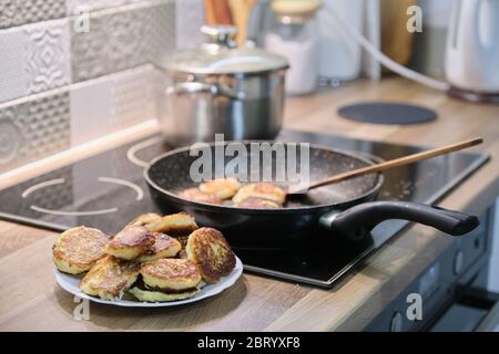 Homemade food, process of cooking frying in pan of cheesecakes, curd pancakes Stock Photo