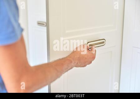 Installation of new cabinet, handyman sets door handles Stock Photo