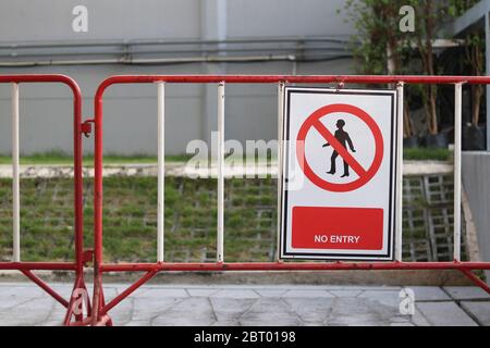 A sign strictly prohibiting this route. No entry sign hanging on iron fence. Stock Photo