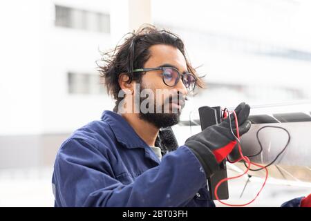 Bearded man wearing eyeglasses working on construction site. Stock Photo