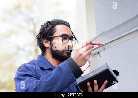 Bearded man wearing eyeglasses working on construction site. Stock Photo