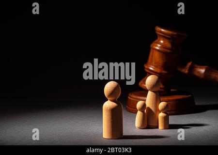 Wooden toy family and judge mallet. Family divorce concept Stock Photo