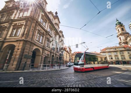 Daily life in city. Modern tram of public transportation in blurred motion. Prague, Czech Republic.