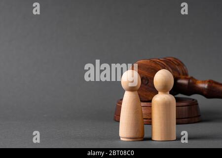 Wooden toy family and judge mallet. Family divorce concept Stock Photo