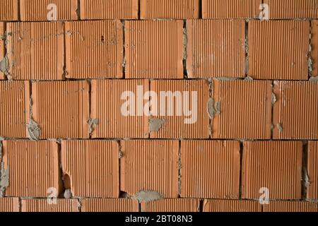 The cement around the seams and a few other bricks. The brick is clean and smooth. Others have white spots and cracks, streaks and scratches. Red big Stock Photo