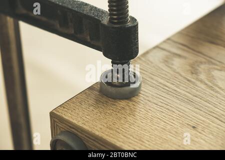 Wooden boards clamped together in the furniture assembly workshop Stock Photo