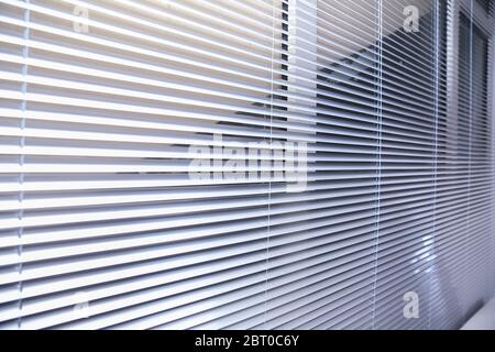 Office blinds. Modern wooden jalousie. Office meeting room lighting range control. venetian blinds by the window . Sunlight coming through venetian Stock Photo