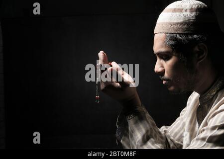 muslim man praying during ramadan at night  Stock Photo