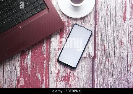 smart phone with empty screen and laptop on wooden background  Stock Photo