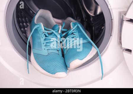 Sneakers inside the washing machine. Close up. Stock Photo