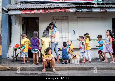 Young Filipino children play in the street in the old walled city of ...