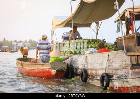 Mekong Delta - Vietnam - January 24, 2019 : Vietnamese vendors buying watermelon on Nga Nam floating market in Mekong Delta Vietnam. Stock Photo