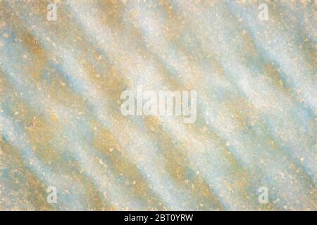 Macro shot of a wavy structure and round pigment-like yellow blobs of paint Stock Photo