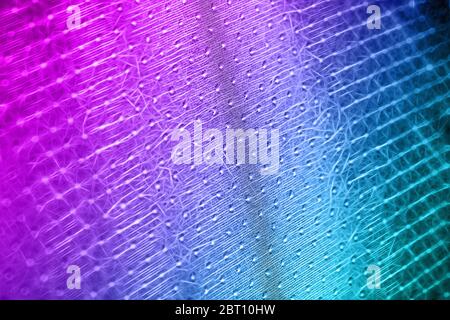 Macro shot of a reticulated, wavy pink-blue surface made up of small flashes Stock Photo