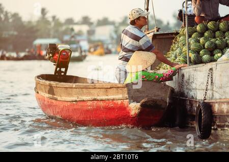 Mekong Delta - Vietnam - January 24, 2019 : Vietnamese vendors buying watermelon on Nga Nam floating market in Mekong Delta Vietnam. Stock Photo