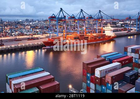 A ship is loaded at the Container Terminal Burchardkai in the port of  Hamburg. Stock Photo