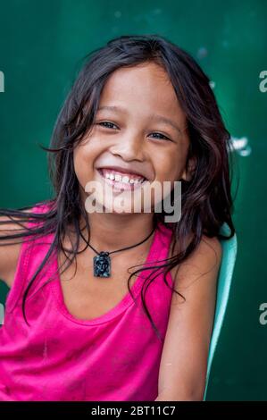 A pretty young Filipino girl poses and smiles for my camera in the old ...