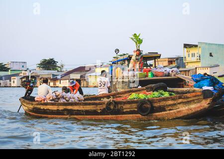 Mekong Delta - Vietnam - January 24, 2019 : Vietnamese vendors buying watermelon on Nga Nam floating market in Mekong Delta Vietnam. Stock Photo