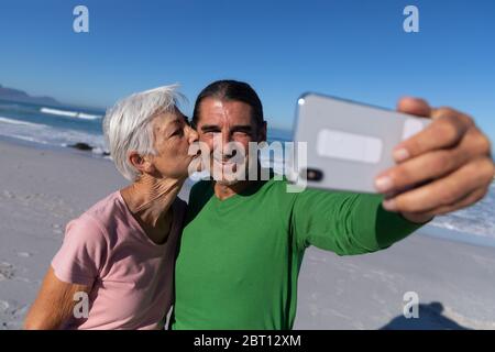Senior Caucasian couple taking a selfie at the beach. Stock Photo