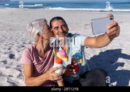 Senior Caucasian couple taking a selfie at the beach. Stock Photo