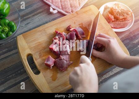 diced raw beef meat on wooden cutting board Stock Photo - Alamy