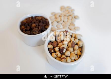 dry fruits isolated in white pots Stock Photo