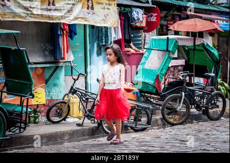 Filipino children hang out in the old walled city of Intramurous, Manila, The Philippines. Stock Photo