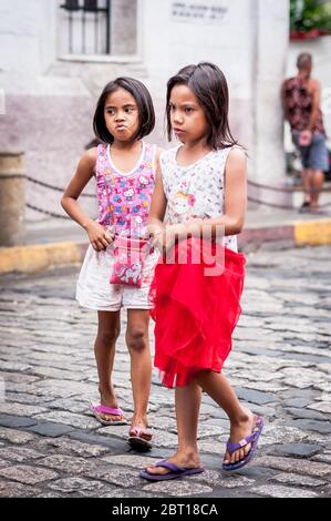 Filipino children hang out in the old walled city of Intramurous, Manila, The Philippines. Stock Photo