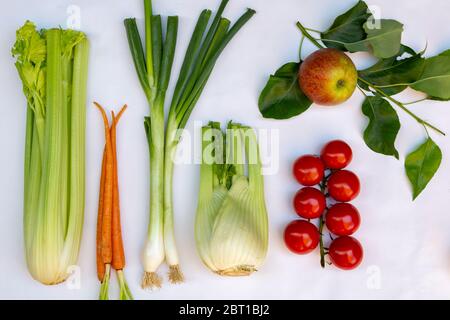 Flat lay with different kinds of fresh local vegetables en fruits like, celery, spring onion, tomato, apple, zucchini, chicory and fennel Stock Photo